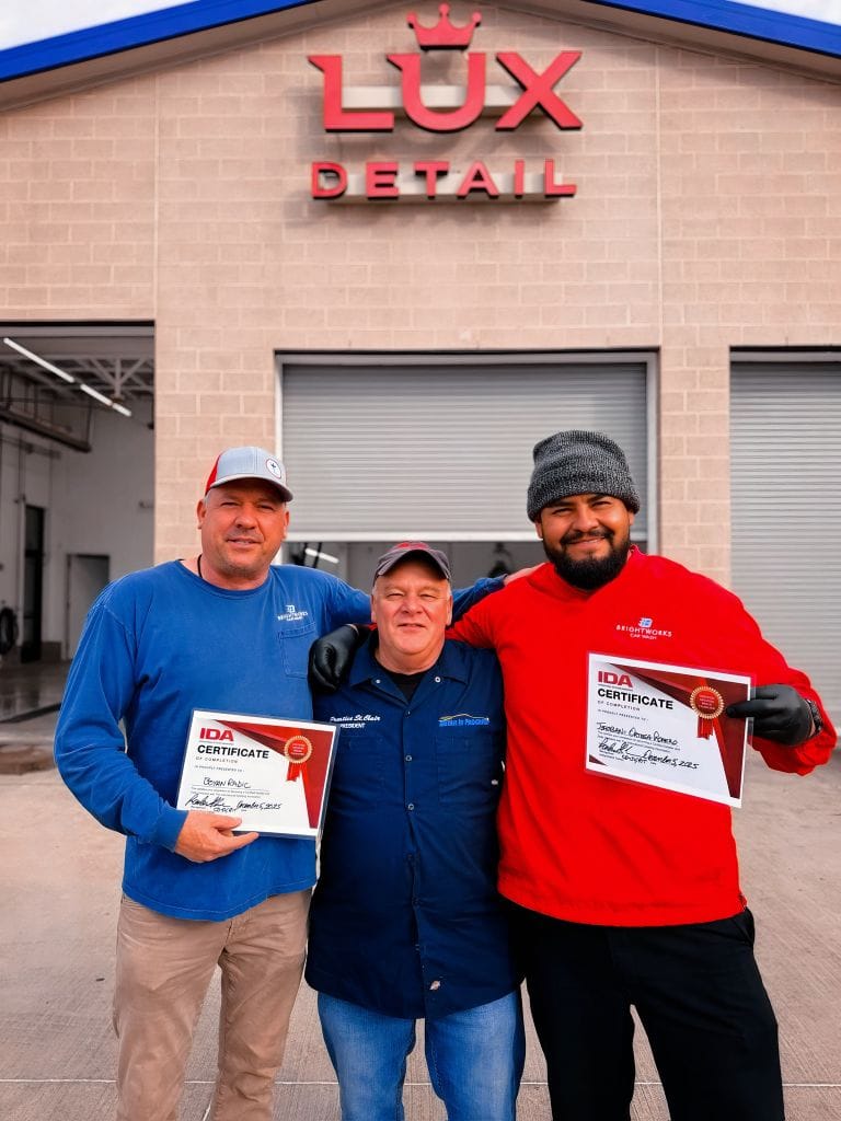 Brightworks Fort Worth team receiving IDA certificates of completion in front of the Lux Detail building