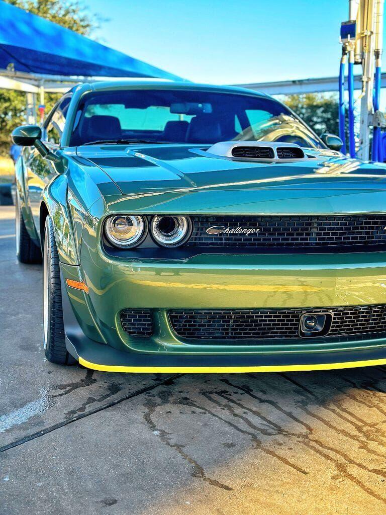 Army-green Dodge Challenger front end showing a deep gloss shine after detailing at Brightworks Granbury