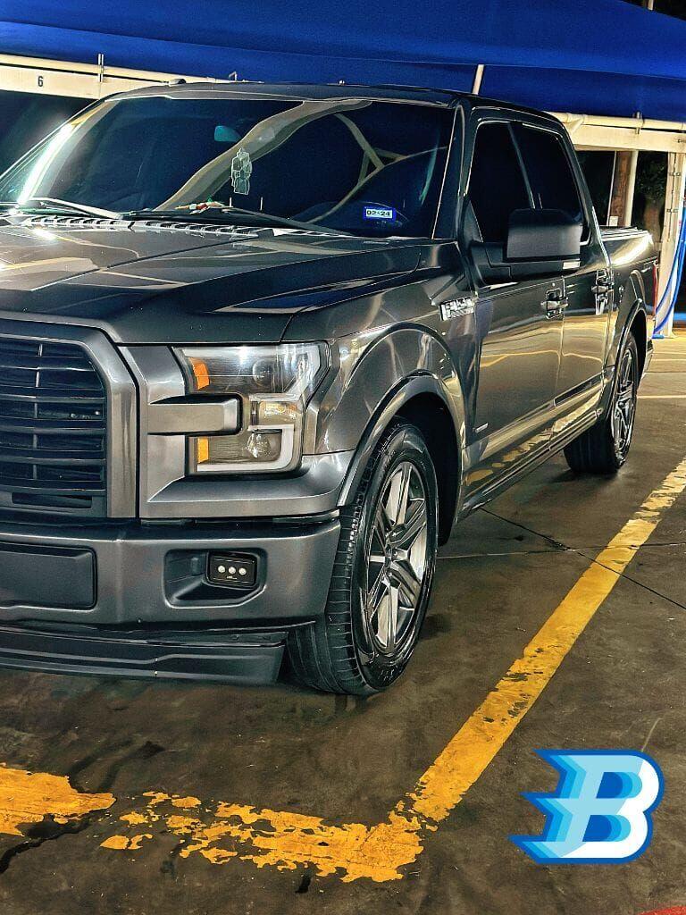 Graphite Ford F-150 freshly detailed under the Brightworks Granbury blue canopy at night