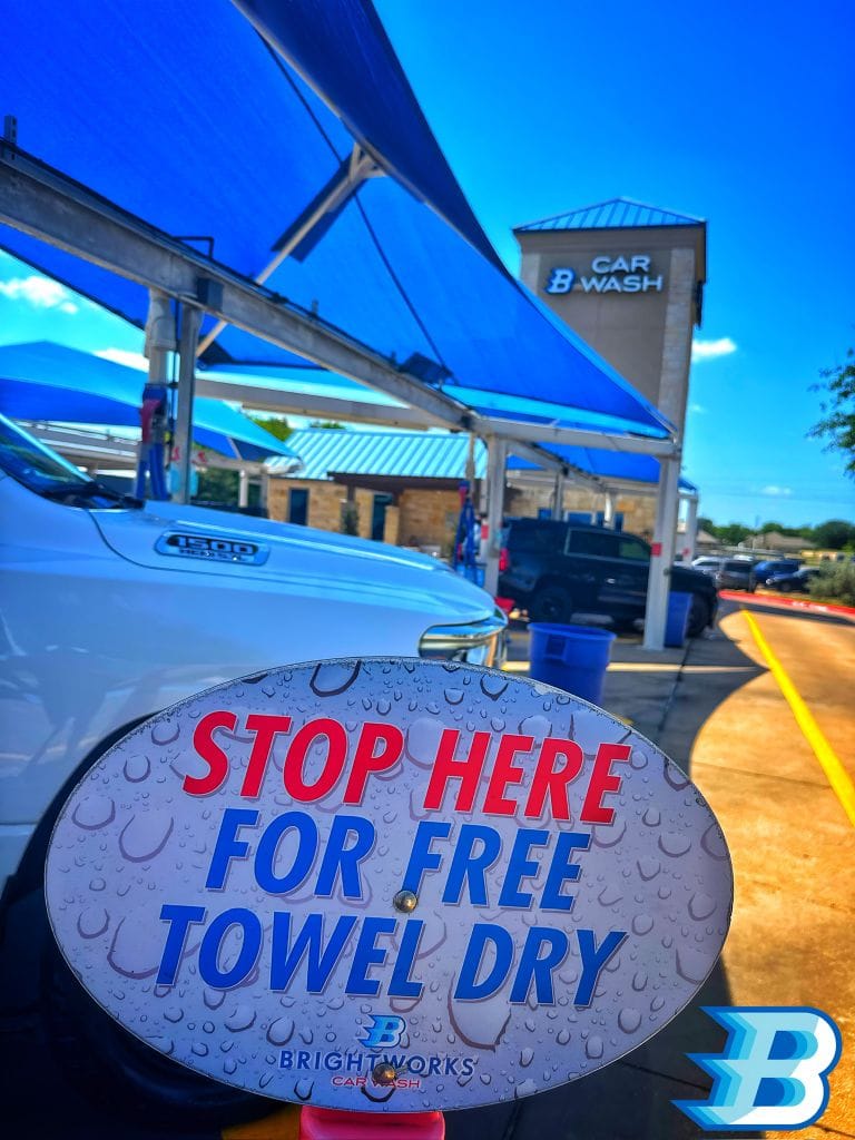 Stop here for free towel dry sign at Brightworks Granbury car wash